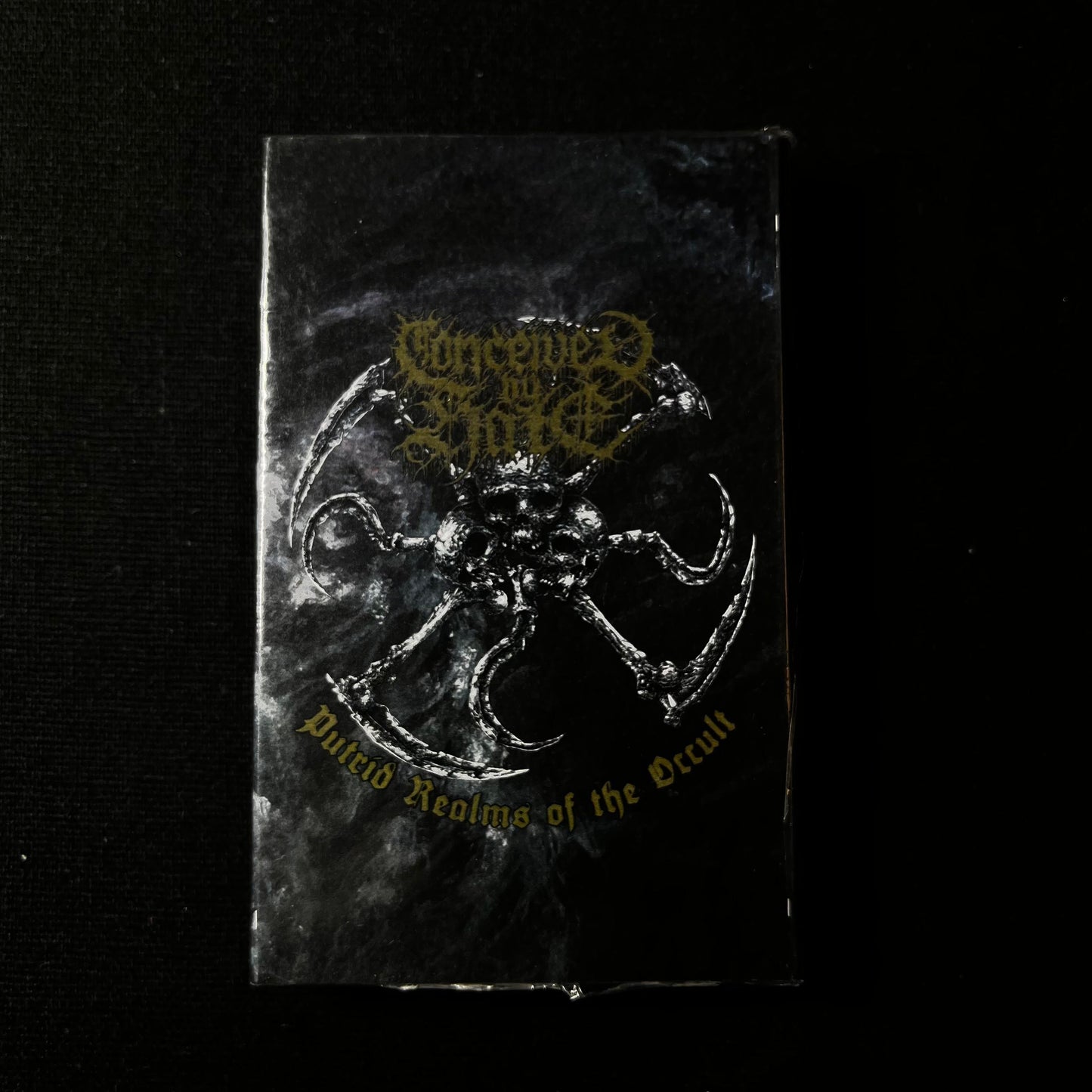 CONCEIVED BY HATE - Putrid Realms Of The Occult Cassete | Black Hearts Records